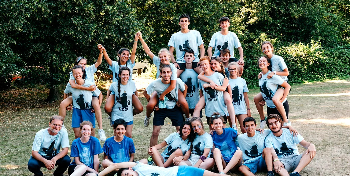 A group of homestay students all wearing blue shirts